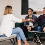 A couple shaking hands with a real estate agent after making as deal